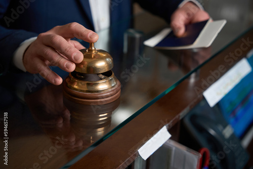 Businessman came to hotel and call in desk bell