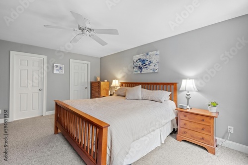 Cozy bedroom interior, furnished with a single bed, dresser and ceiling fan photo