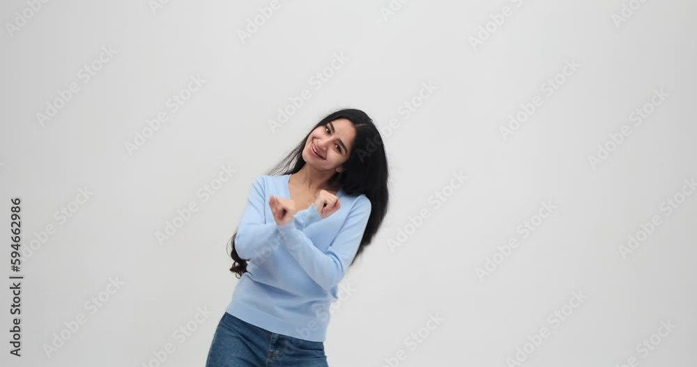 Carefree young woman dancing over white background Carefree young woman dancing over white background