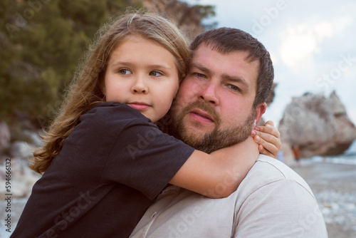 Daughter hugging dad outdoors. walking at the beach, beautiful nature © shapovalphoto