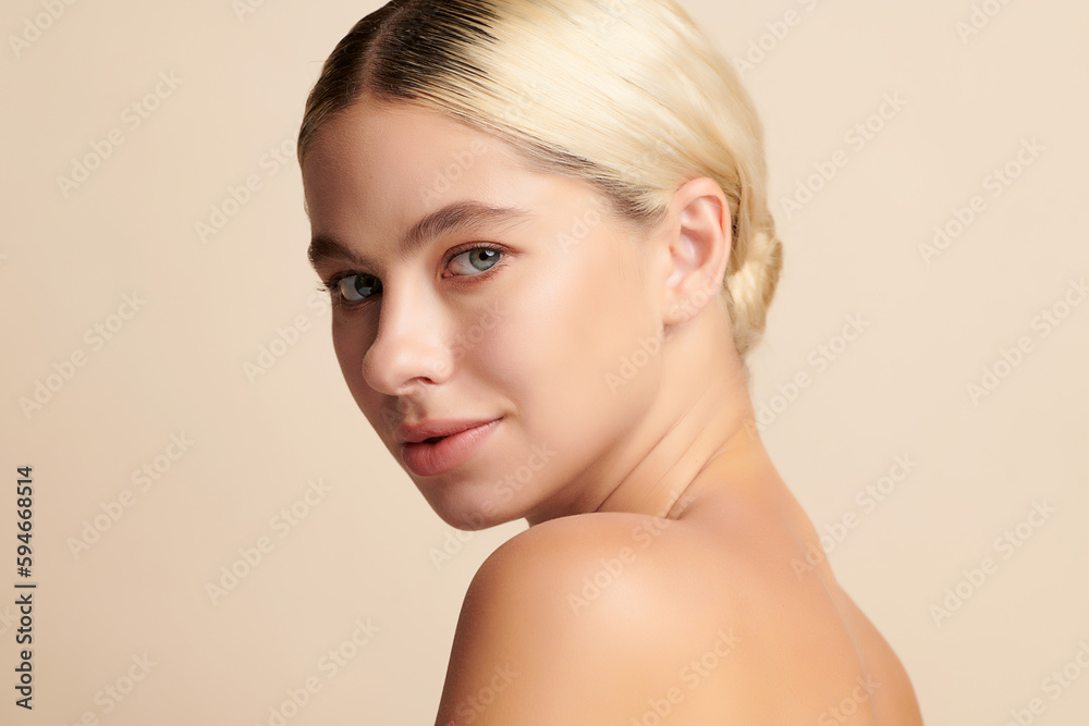 Beautiful young woman with clean fresh skin on beige background, Face care, Facial treatment, Cosmetology, beauty and spa,