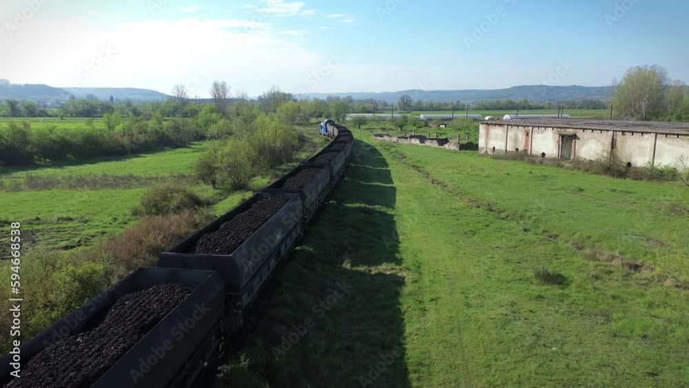 Transportation of coal to thermal power plants.Train with many cars carrying coal. Arial view Transportation of coal to thermal power plants.Train with many cars carrying coal. Arial view