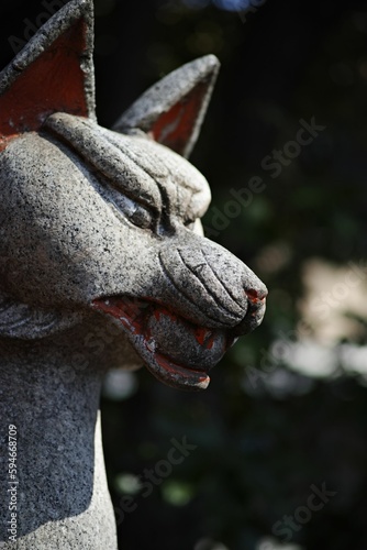 Bronze sculpture of a canine head with blurred background