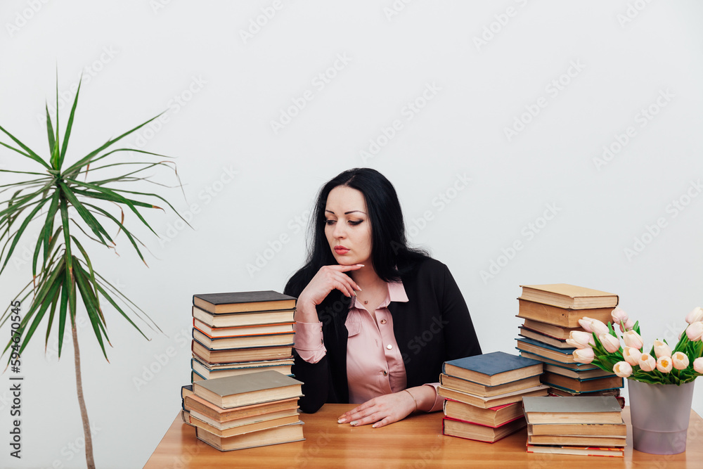 woman with a stack of books in the library training science education woman with a stack of books in the library training science education