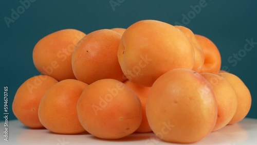 Wallpaper Mural Closeup view 4k stock video footage of many fresh riped juicy orange apricots laying on white plate isolated on blue background Torontodigital.ca