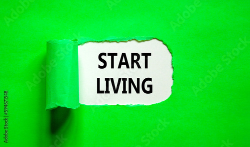 Start living symbol. Concept words Start living on beautiful white paper. Beautiful green table green background. Business and Start living concept. Copy space.