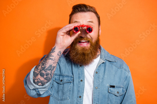 Canvas Print Photo of funny young hipster redhair beard man hold theater binoculars glasses w