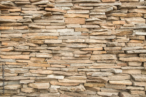 House garden stone wall made of sandstone slabs closeup as stone background