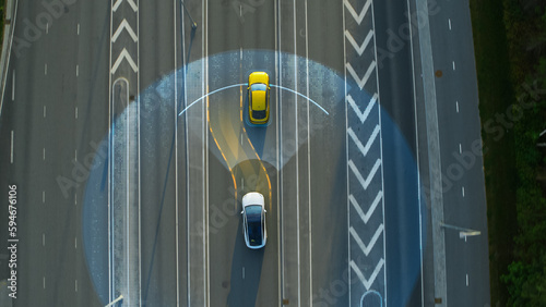 Принти на полотні Aerial Top Down View: Autonomous Self Driving Car Moving Through City, Passing Other Vehicles