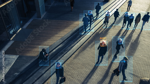 Elevated Security Camera Surveillance Footage of a Crowd of People Walking on Busy Urban City Streets. CCTV AI Facial Recognition Big Data Analysis Interface Scanning, Showing Private Information.