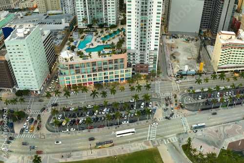 View from above of street traffic and skyscraper buildings in downtown district of Miami Brickell in Florida, USA. American megapolis with business financial district