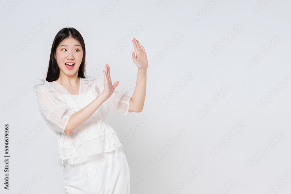 Young woman act like a pushing something isolated on white background. Surprised happy woman looking copy space in excitement. Presenting some product. Young woman act like a pushing something isolated on white background. Surprised happy woman looking copy space in excitement. Presenting some product.
