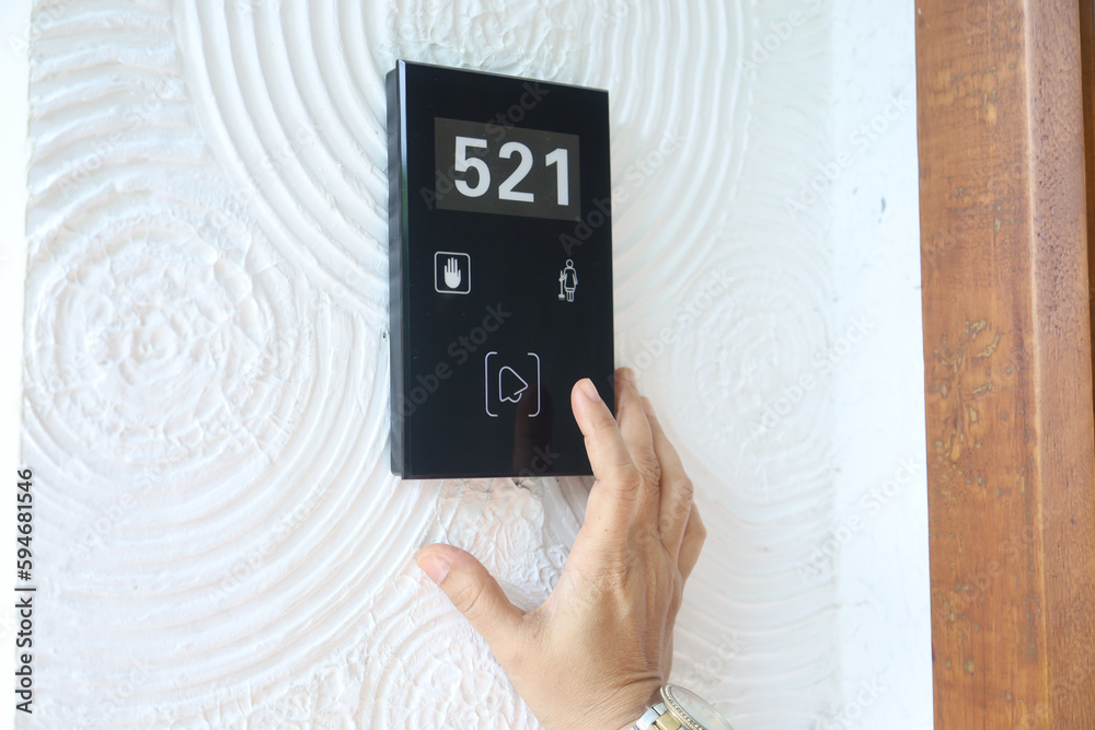 Hand Presses Bell Button On Hotel Room Door Digital Room Key Card And 