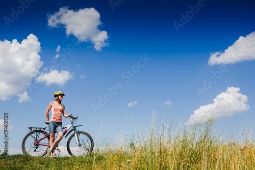 Mountain biking - woman with bike enjoy summer vacation © olyphotostories