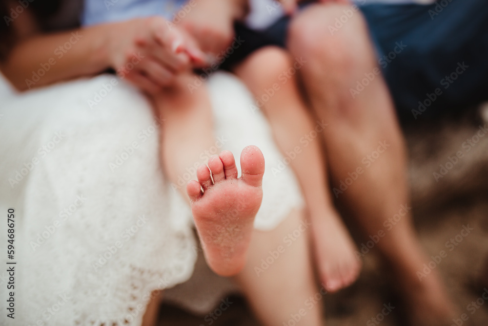 family and child sandy feet at a beach. family and child sandy feet at a beach.