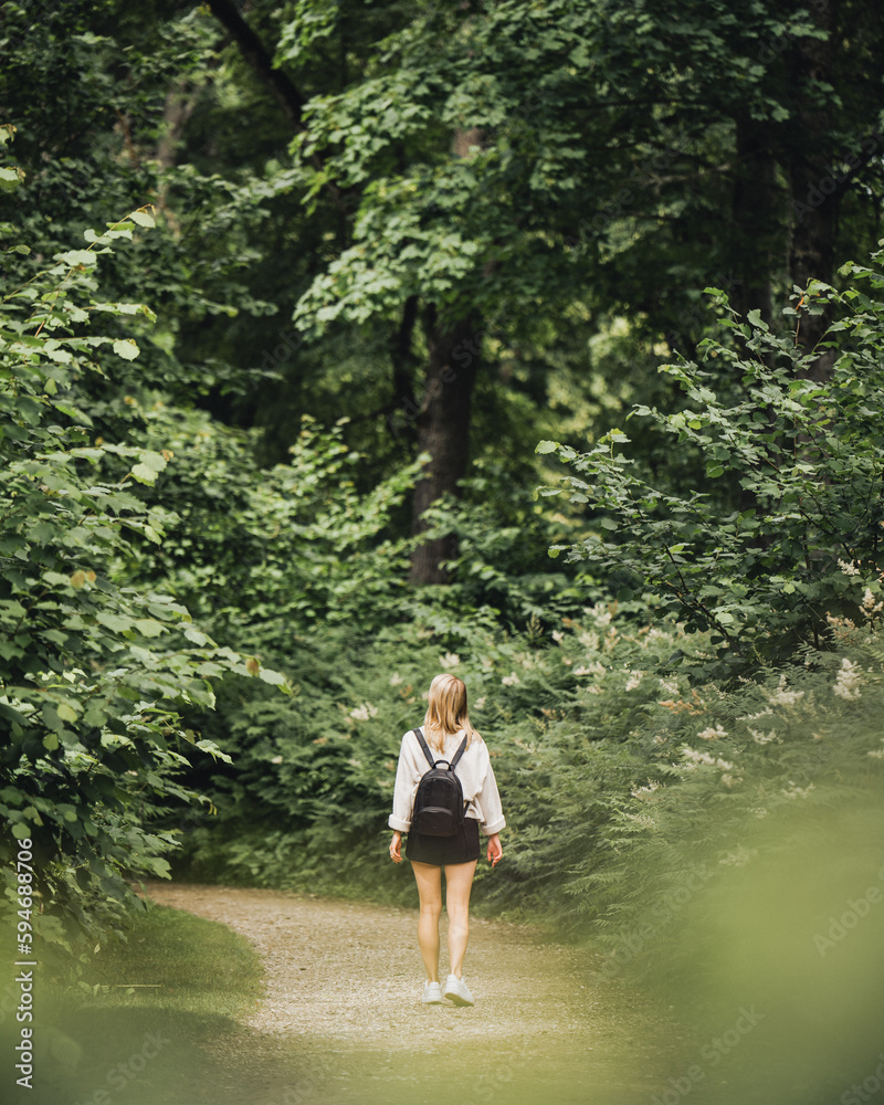 Woman On A Beautiful Green Forest Hiking Trail Woman On A Beautiful Green Forest Hiking Trail