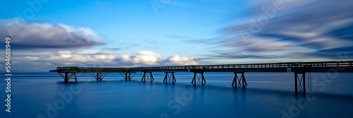Wooden pier extending into the distance in Sidney Pier, Sidney, BC, Canada © David Hutchison/Wirestock Creators