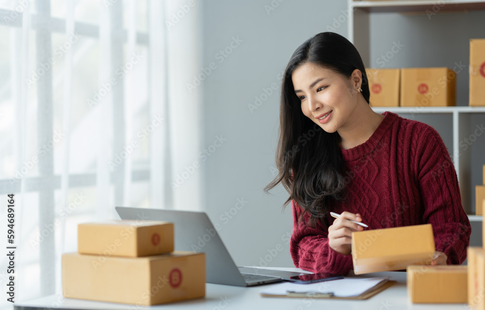 Business woman owner holding parcel box Verify the correctness in the list, address, customer phone number for parcel delivery through the express delivery company. startup business ideas. Business woman owner holding parcel box Verify the correctness in the list, address, customer phone number for parcel delivery through the express delivery company. startup business ideas.