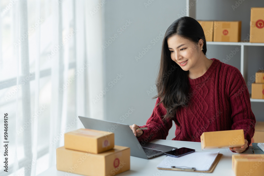 Business woman owner holding parcel box Verify the correctness in the list, address, customer phone number for parcel delivery through the express delivery company. startup business ideas. Business woman owner holding parcel box Verify the correctness in the list, address, customer phone number for parcel delivery through the express delivery company. startup business ideas.