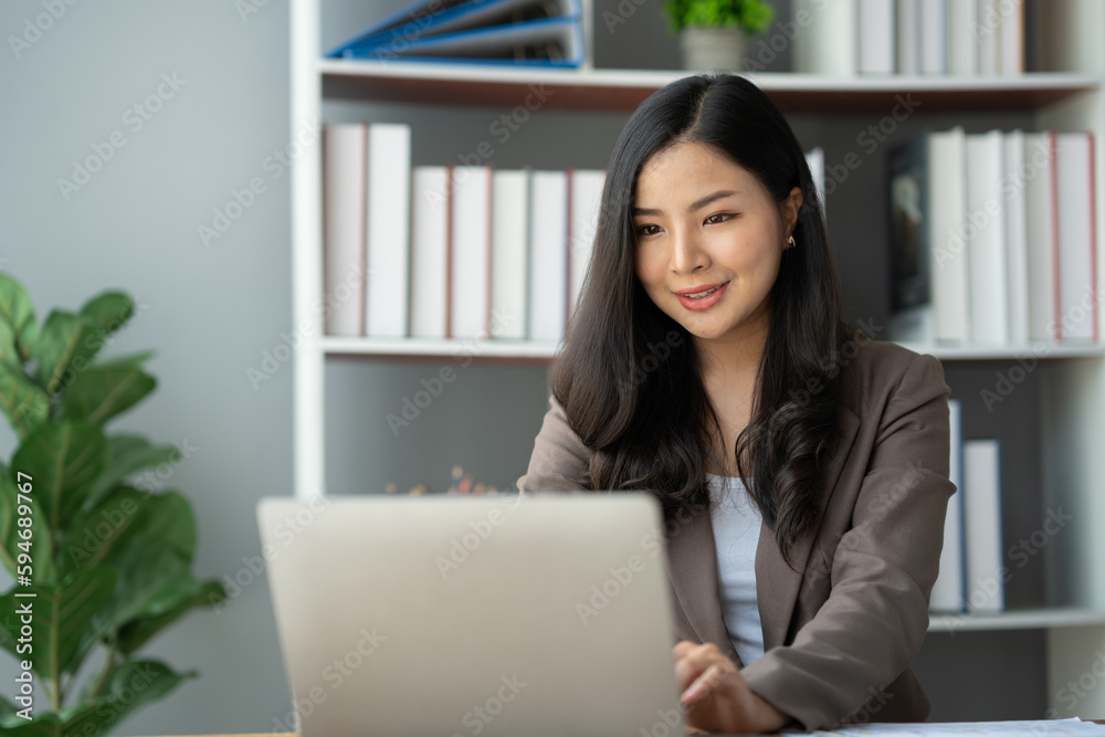 Asian businesswoman, self-employed working on laptop computer typing e-commerce marketing financial report on real estate project in office management concept. Asian businesswoman, self-employed working on laptop computer typing e-commerce marketing financial report on real estate project in office management concept.