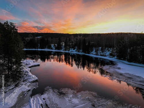Landscape of a pond surrounded by a forest during a breathtaking sunset in Hamar, Norway photo