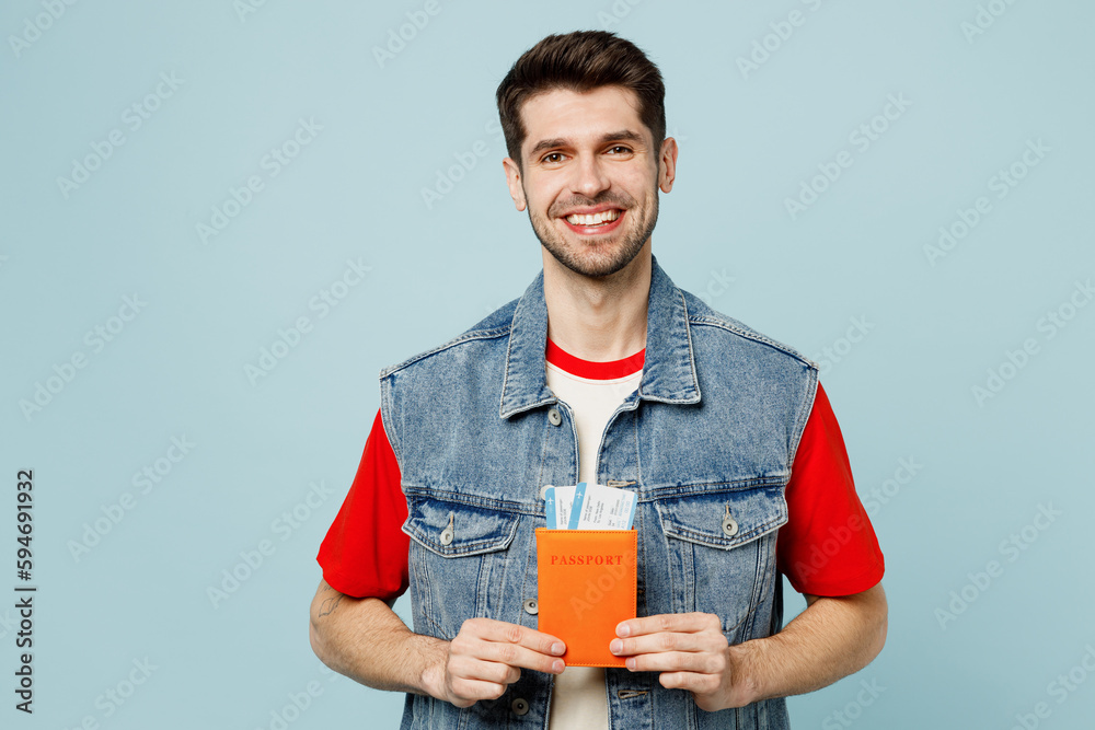 Traveler smiling happy man wear casual clothes hold passport ticket isolated on plain pastel blue cyan background Tourist travel abroad in free spare time rest getaway Air flight trip journey concept Traveler smiling happy man wear casual clothes hold passport ticket isolated on plain pastel blue cyan background Tourist travel abroad in free spare time rest getaway Air flight trip journey concept