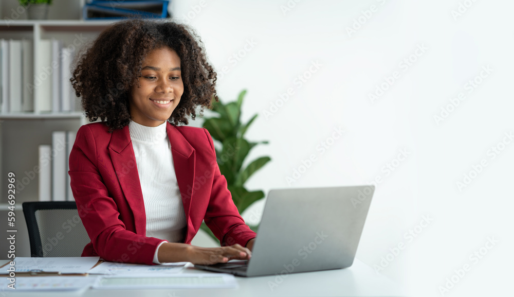 African american businesswoman sitting and recording data details in ...
