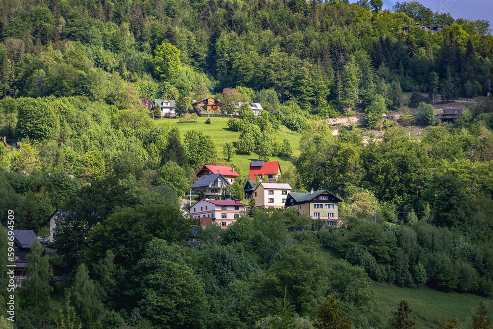 Houses on a slope in Szczyrk village in Silesian Beskids mountain range, Poland