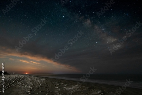 Landscape of a beach under a beautiful starry sky in the evening
