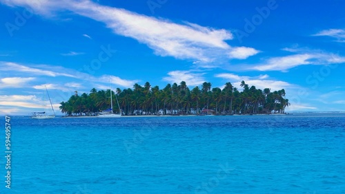 the beautiful view of an island on a clear day in the water