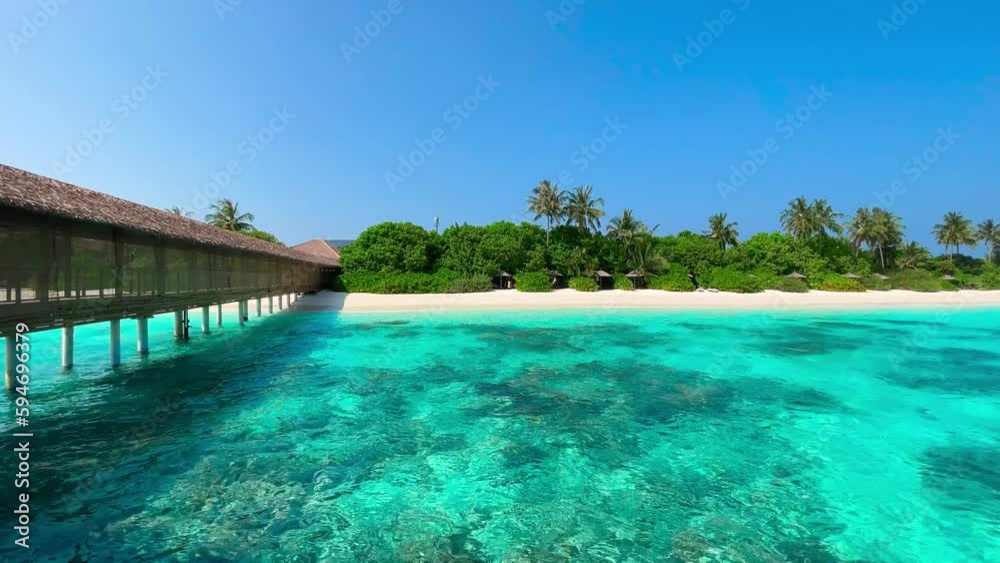 View of the Maldivean coastline from the turquoise sea. View of the Maldivean coastline from the turquoise sea.