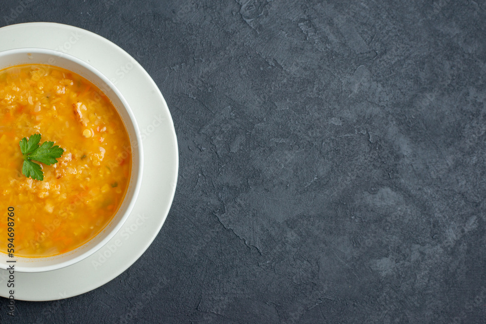 top view delicious soup inside white plate on dark surface food diner colourful meal bread horizontal dish free space top view delicious soup inside white plate on dark surface food diner colourful meal bread horizontal dish free space