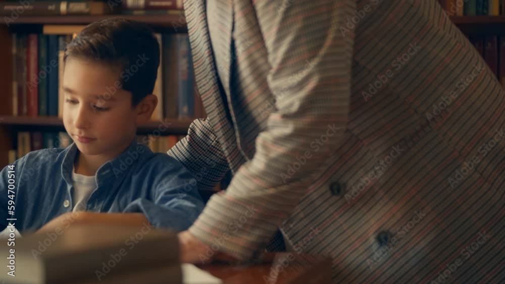 Kind teacher praising diligent schoolboy during lesson in classroom, education Kind teacher praising diligent schoolboy during lesson in classroom, education