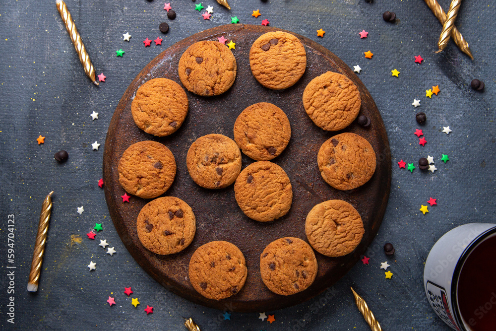 top close view delicious chocolate cookies with candles and tea on the dark background cookie biscuit tea sweet