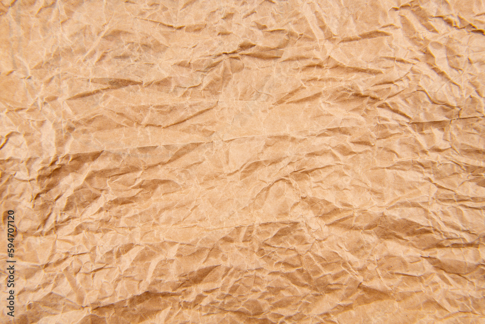 Fototapeta premium Brown crumpled paper background vignette