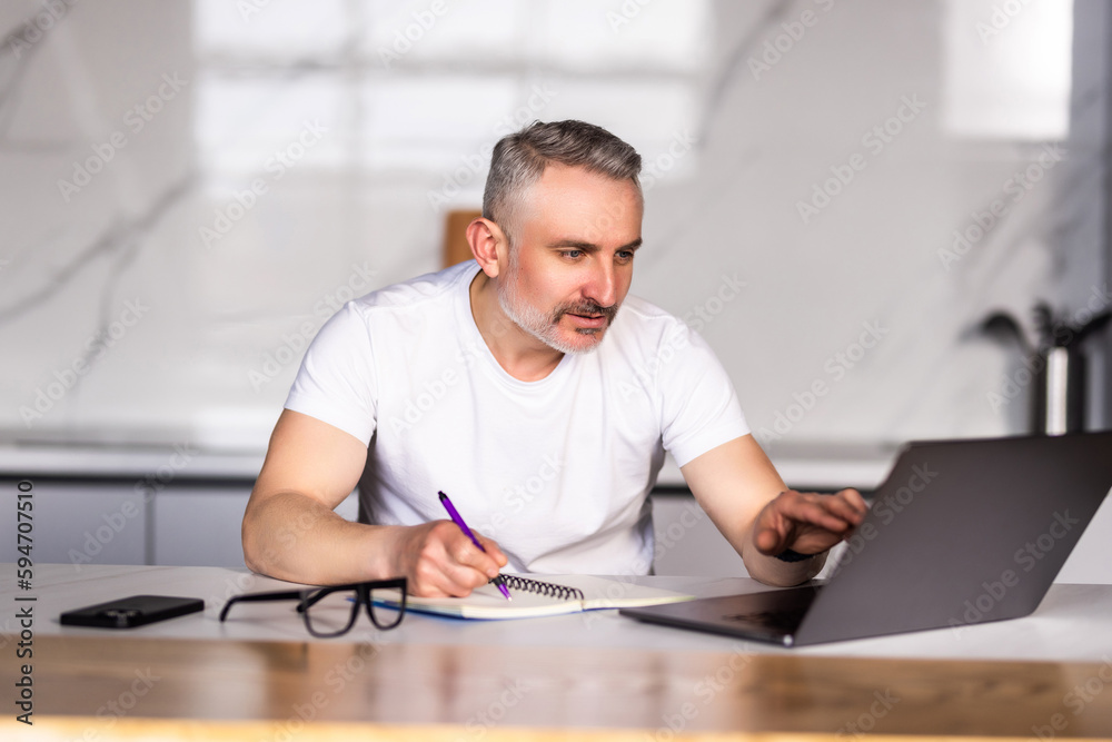 Happy middle age homeowner man getting good news about income, money, personal finance, doing domestic financial work, calculating budget, savings, benefits, paying bills, insurance fees Happy middle age homeowner man getting good news about income, money, personal finance, doing domestic financial work, calculating budget, savings, benefits, paying bills, insurance fees