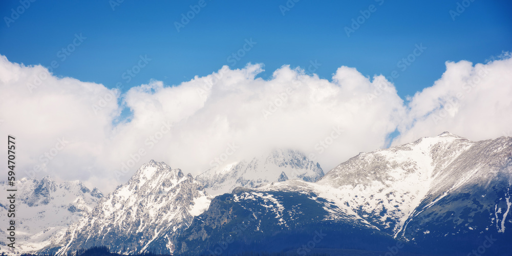 background image of high tatra peaks in spring. sunny scenery with clouds