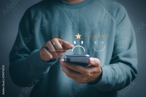 concept, bad experiences or bad service and dissatisfied customers ,man using smartphone Rate dissatisfaction with sad face icon with one star. show minimal dissatisfaction