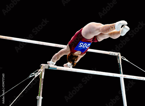 female gymnast exercise on uneven bars in gymnastics, black background, sports summer games