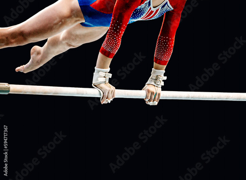 Canvastavla close-up female gymnast exercise on uneven bars in artistic gymnastics, black ba