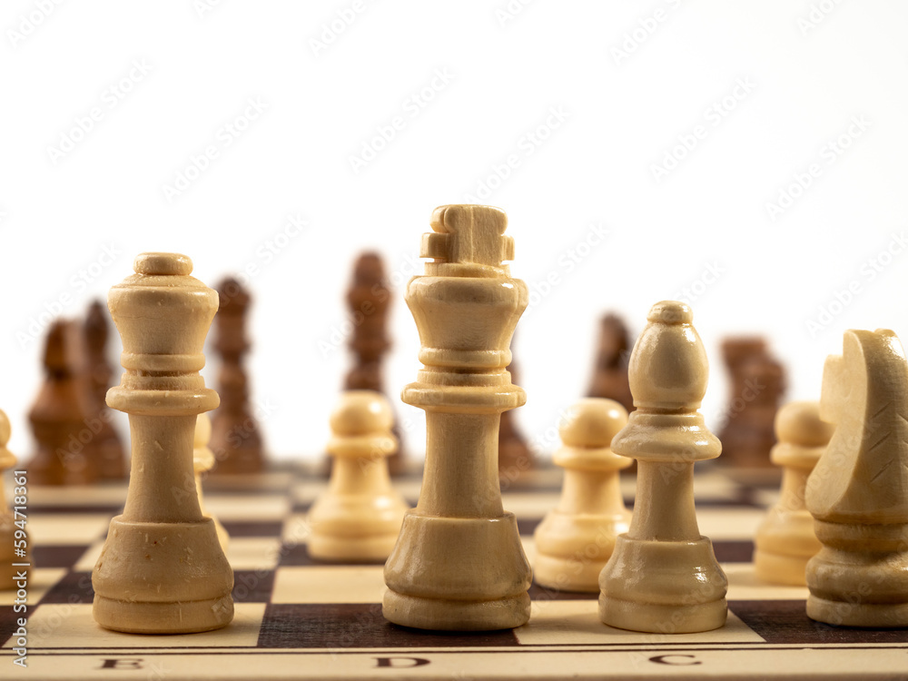 Wooden chess on a white background. Board game chess. Close-up. Wooden chess on a white background. Board game chess. Close-up.