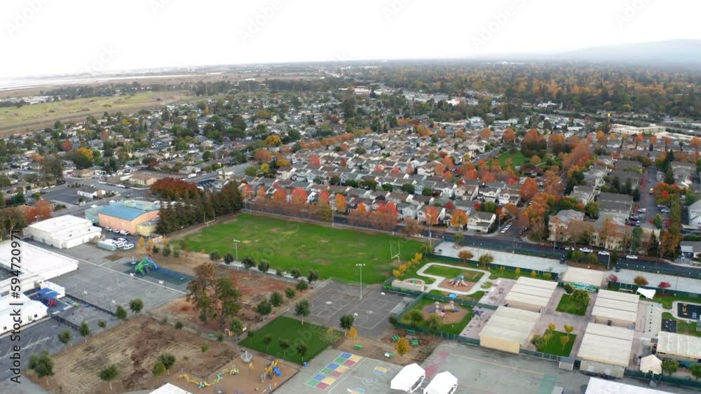 Drone view over residential and industrial areas and trees in California Drone view over residential and industrial areas and trees in California