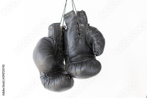 hanging old worn leather boxing gloves isolated on white background © OLEKSANDR