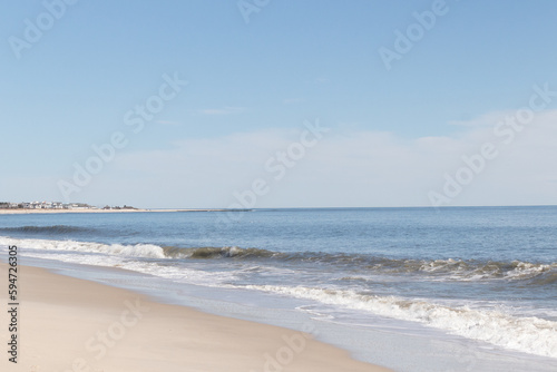 This beautiful beach image was taken at Cape May New Jersey. It shows the waves rippling into the shore and the pretty brown sand. The blue sky with the little bit of cloud coverage adds to this.
