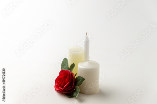 light candles with red rose on white background flame lamp fire