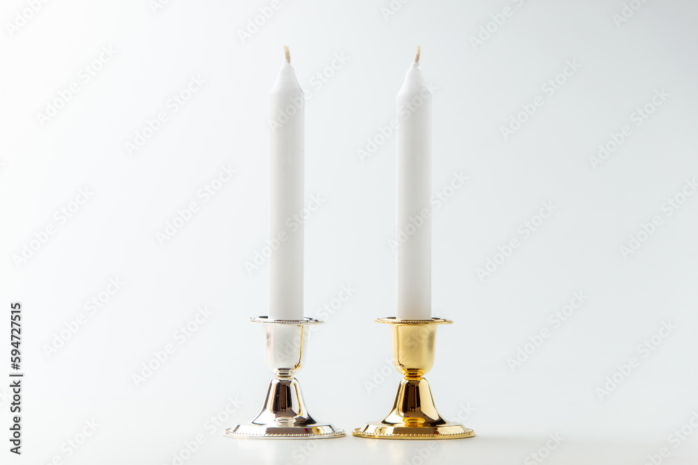white candles inside elegant candlesticks on white background flame lamp steel metallic white candles inside elegant candlesticks on white background flame lamp steel metallic