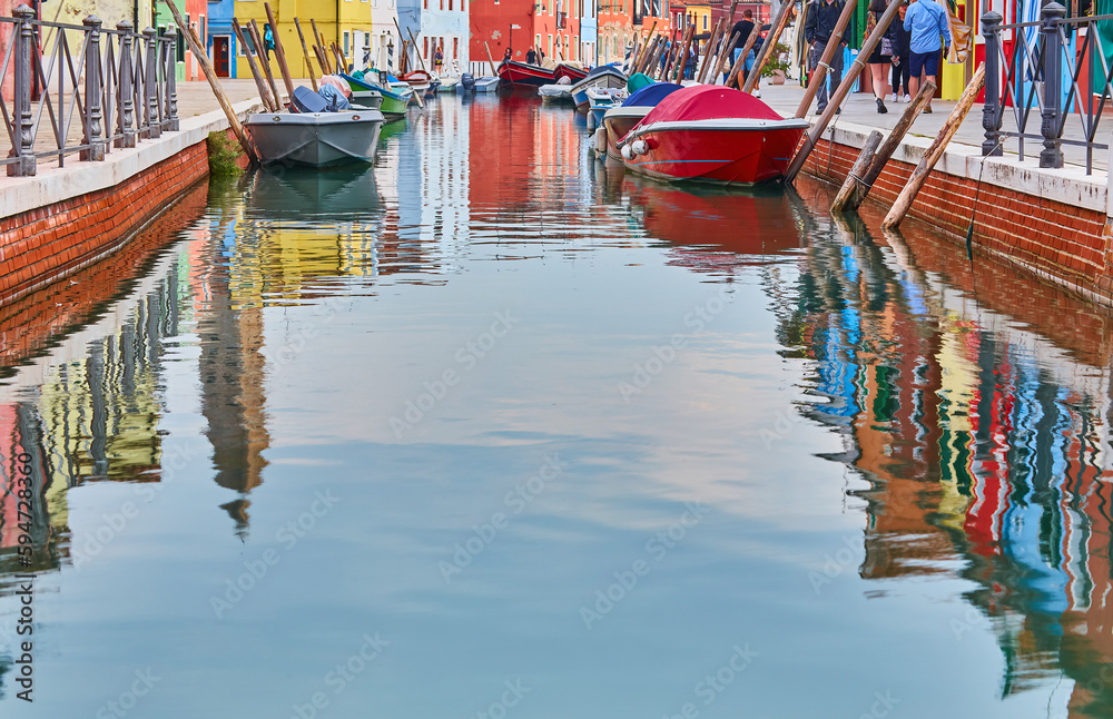 Fototapeta premium Colorful architecture and canal with boats in Burano island, Venice, Italy. Famous travel destination.