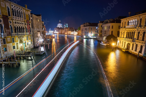 Cityscape image of Grand Canal in Venice, with Santa Maria della Salute Basilica in the background.