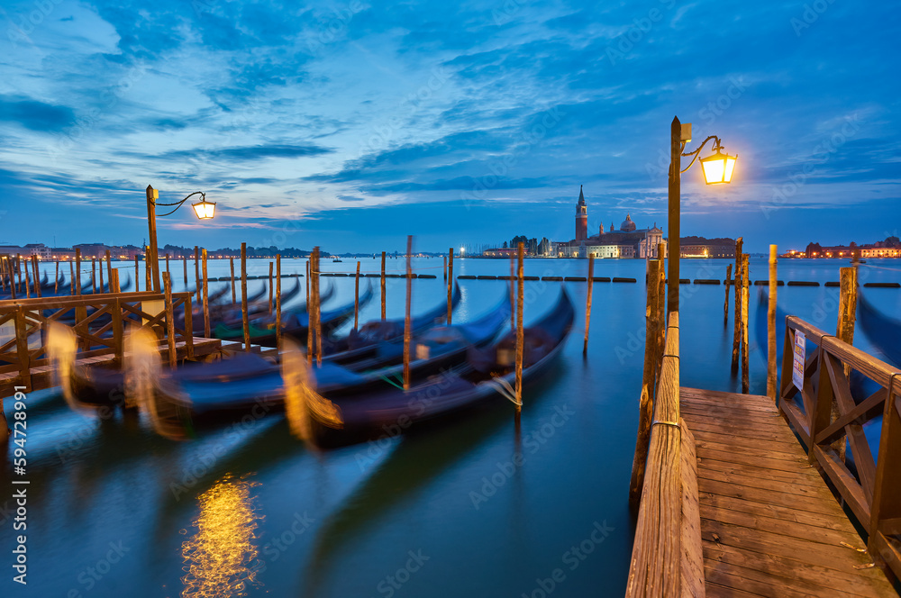 Gondolas at the St. Marks square in Venice, before a dramatic sunrise Gondolas at the St. Marks square in Venice, before a dramatic sunrise