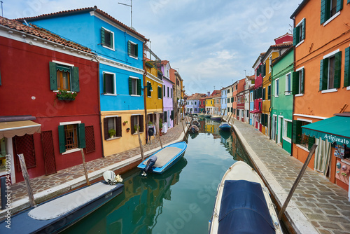 Colorful architecture and canal with boats in Burano island, Venice, Italy. Famous travel destination. © Ryzhkov Oleksandr